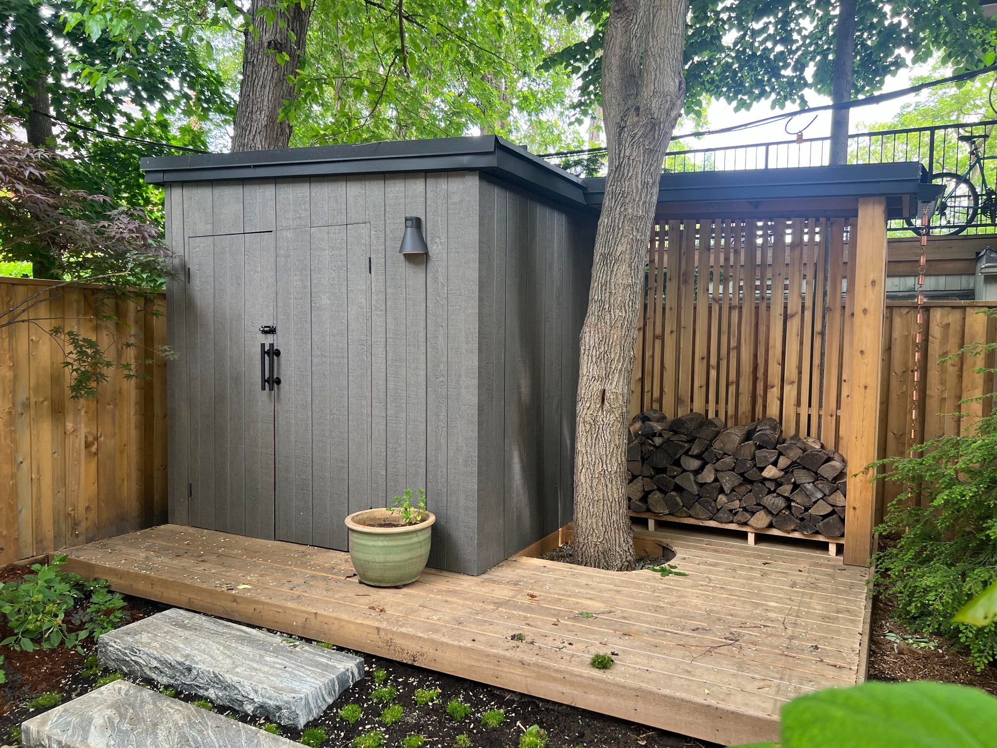 Modern custom garden storage building with integrated firewood shelter