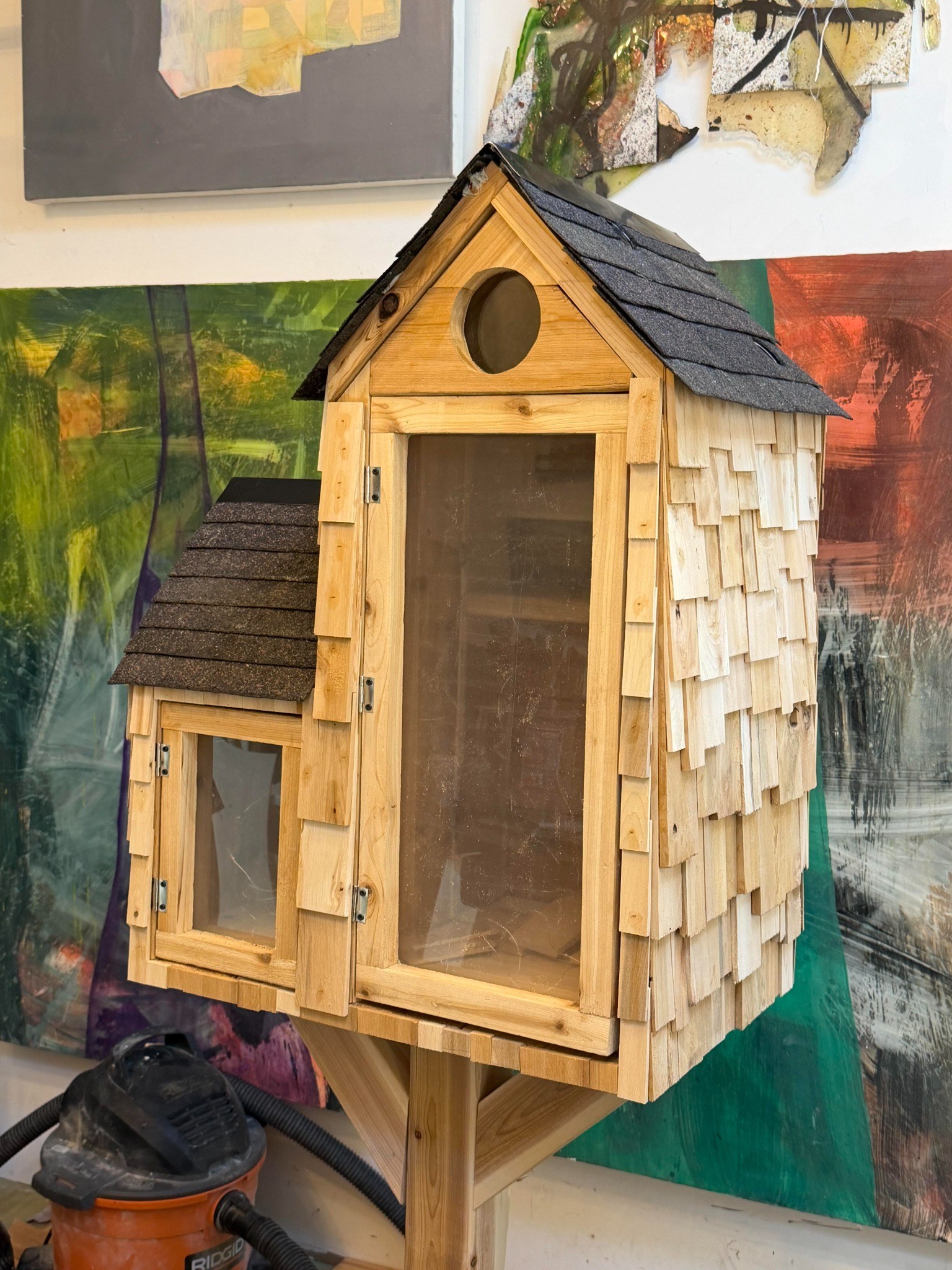 Three-quarter workshop view of a handcrafted cedar Little Library